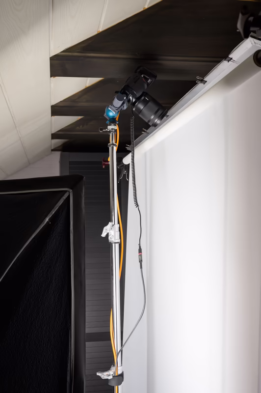 Behind-the-scenes view of a photoshoot at mmiri studio, showing the setup for photographing the Acqua di Gioia perfume bottle.